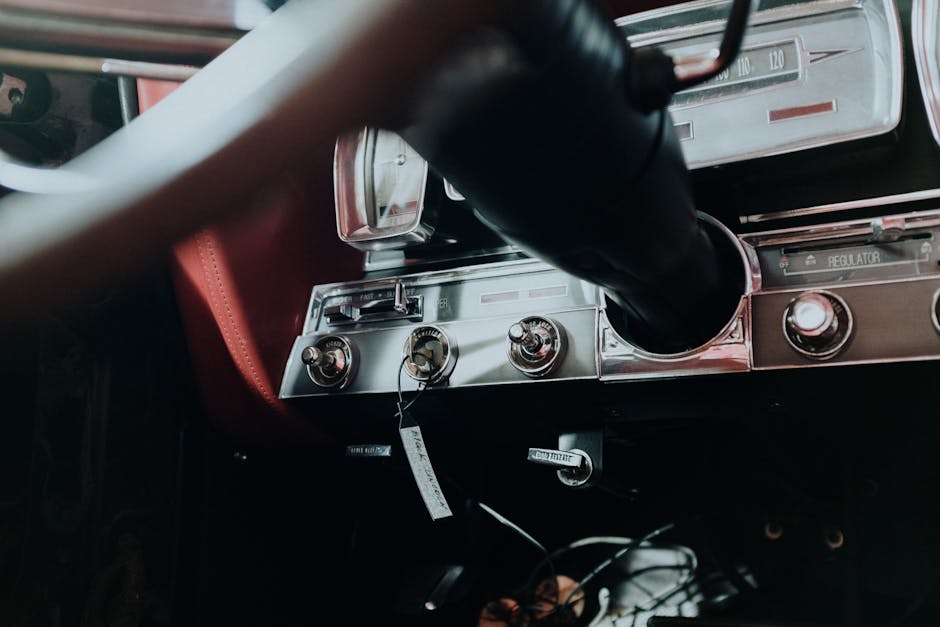 Close-up of a vintage car dashboard showcasing classic instruments and design elements.